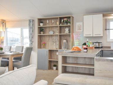 A kitchen with dining area and shelves at 2 Summerleaze in Bude