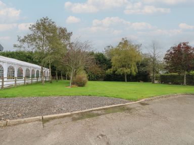 An outdoor area with a tent and trees at Pompian Lodge Leyland