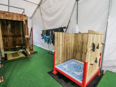 An outdoor shower area with wooden enclosure at Pompian Lodge in Bretherton near Tarleton