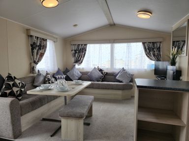 A living room with a sofa and dining area at 123 Elms in 