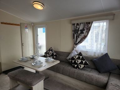 A living room with a sofa and dining table at 123 Elms in 