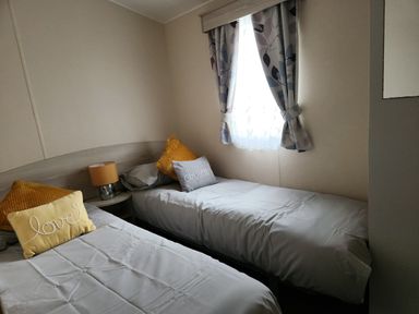 A bedroom with two beds near a window at 123 Elms 