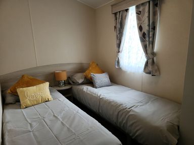 A bedroom with two beds and a window at 123 Elms