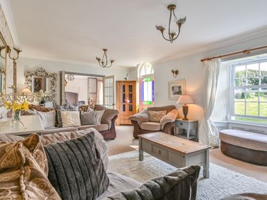 A living room with a coffee table and sofas at The Old Farm House near Pelynt