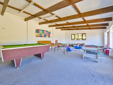 A games room with a pool table and foosball table at The Old Farm House near Pelynt