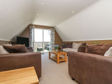 A living room with a sofa and table at Valley Lodge 61 Callington