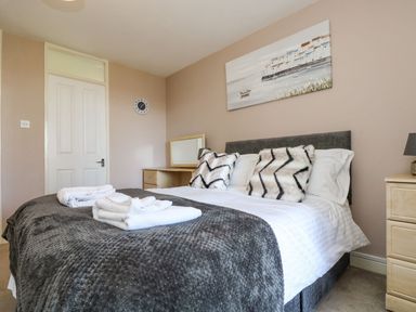 A bedroom with a bed and mirror at Valley Lodge 61 Callington