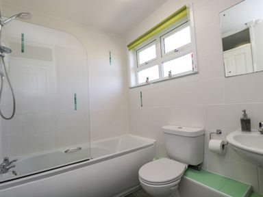 A bathroom with a bathtub and shower at Valley Lodge 61 in Callington