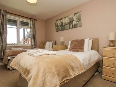 A bedroom with two beds and nightstands at Valley Lodge 61, Callington