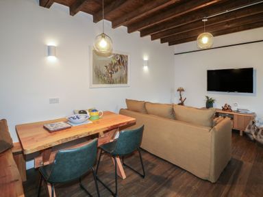 A living room with a sofa and dining table at The Loft in Glenmore, County Kilkenny