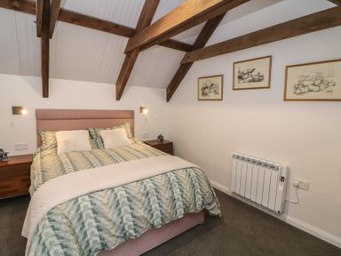 A bedroom with a bed and wall art at The Loft in Glenmore, County Kilkenny
