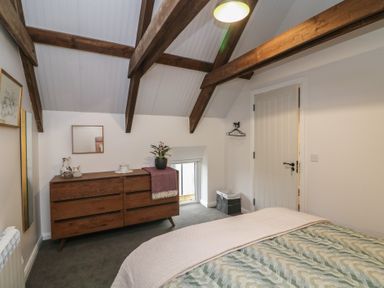 A bedroom with a bed and dresser at The Loft in Glenmore, County Kilkenny