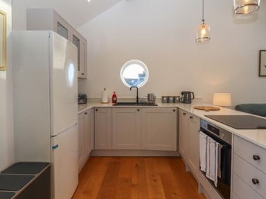 A kitchen with sink and refrigerator at Hilldown Granary near Bow