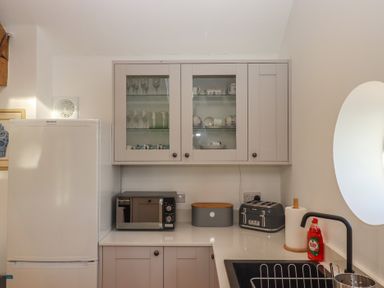A kitchen with appliances and glassware at Hilldown Granary near Bow