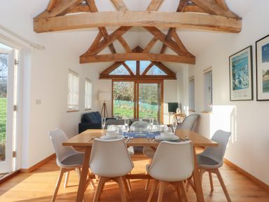 A dining area with a table and chairs at Hilldown Cott near Bow