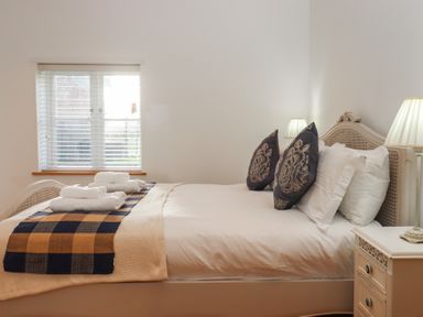 A bedroom with a bed and pillows at Hilldown Cott near Bow