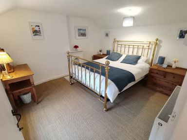 A bedroom with a bed and nightstands at Noddfa in Penmachno