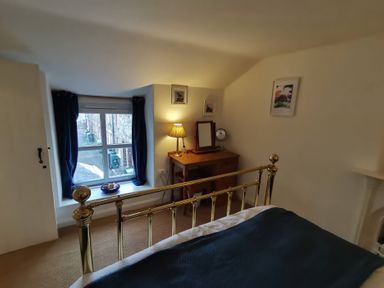 A bedroom featuring a bed and a window at Noddfa Penmachno