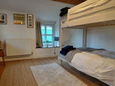 A bedroom with a bunk bed and window at Noddfa in Penmachno