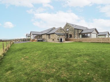 A house with a lawn and fence at 2 Trem Y Mor Llanfwrog near Llanfachraeth