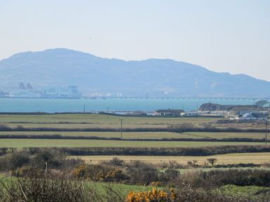 A view including a ferry and mountain at Hen Penmynydd in Llanfwrog near Llanfachraeth