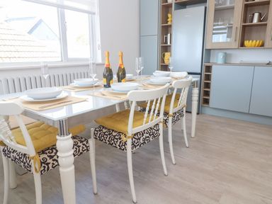 A dining room with a table set for a meal at Shearwater in Praa Sands