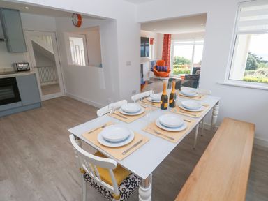 A dining room with a table set for meals at Shearwater in Praa Sands
