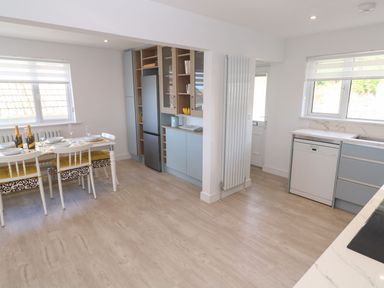 A kitchen with a dining table and chairs at Shearwater in Praa Sands