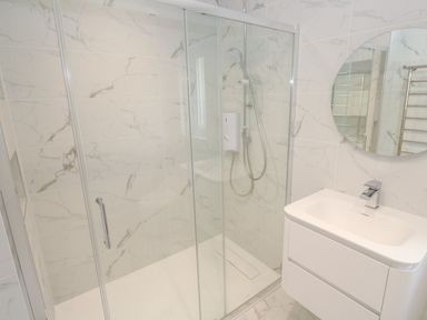 A bathroom with a shower and sink at Shearwater in Praa Sands