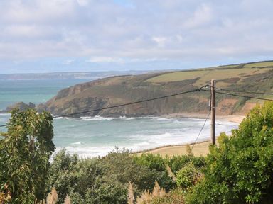 A coastal view with a beach and cliffs at Shearwater in Praa Sands