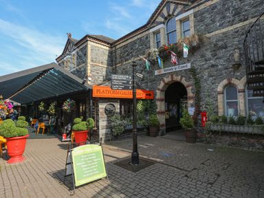 An outdoor area with a signpost and seating at Green Bank in Betws-Y-Coed
