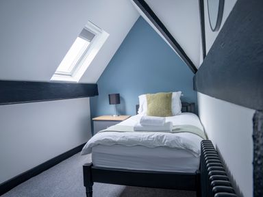 A bedroom with a single bed and bedside table at Green Bank in Betws-Y-Coed