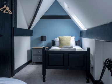 A bedroom with a single bed and a nightstand at Green Bank in Betws-Y-Coed
