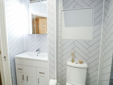 A bathroom with a sink and toilet at 16 Ffordd Meigan Beaumaris