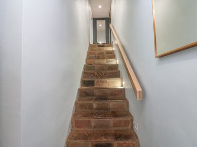 A staircase with stone steps and light fixtures at Chapel Hill in Catlowdy