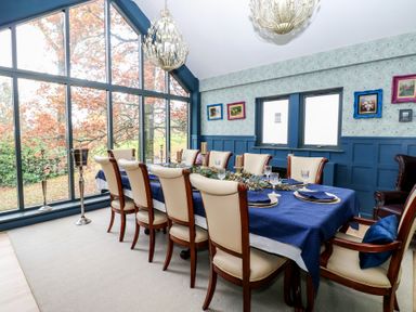 A dining room with a table and chairs at Chapel Hill in Catlowdy