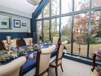 A dining room with a table set for dinner at Chapel Hill, Catlowdy