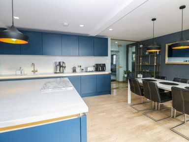 A kitchen with a dining area and appliances at Chapel Hill in Catlowdy