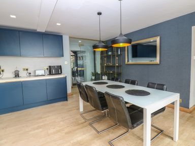 A dining room with a table and chairs at Chapel Hill in Catlowdy