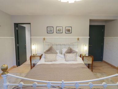 A bedroom with a bed and bedside tables at Chapel Hill in Catlowdy