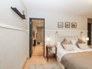 A bedroom with a bed and adjoining bathroom at Chapel Hill in Catlowdy