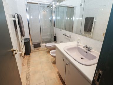 A bathroom with a shower and sink at Chapel Hill in Catlowdy