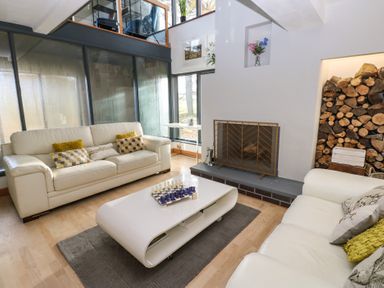 A living room with sofas and a fireplace at Chapel Hill in Catlowdy
