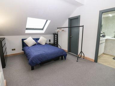 A bedroom with a bed and dresser at Chapel Hill in Catlowdy