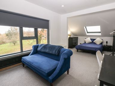 A bedroom with a sofa and bed at Chapel Hill in Catlowdy