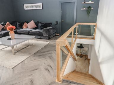 A living room with a sofa and coffee table at Chapel Hill in Catlowdy