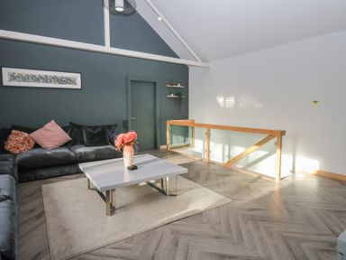 A living room with a sofa and coffee table at Chapel Hill in Catlowdy