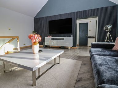 A living room with a coffee table and sofa at Chapel Hill in Catlowdy