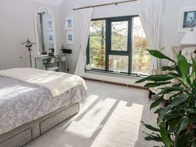 A bedroom featuring a bed and a window at Chapel Hill, Catlowdy