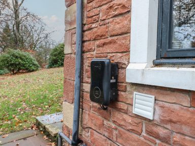 An electric meter and vent on a brick wall at Chapel Hill in Catlowdy